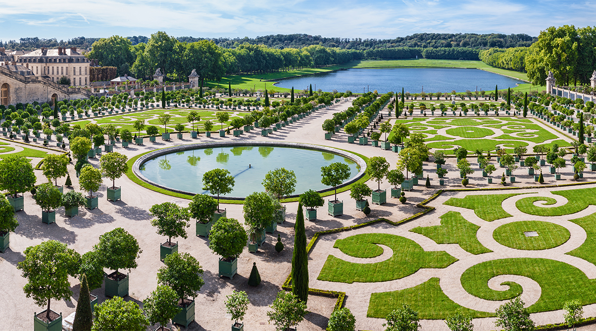 Looking down over Versailles’s elegant gardens designed in the French tradition and beyond to a lake